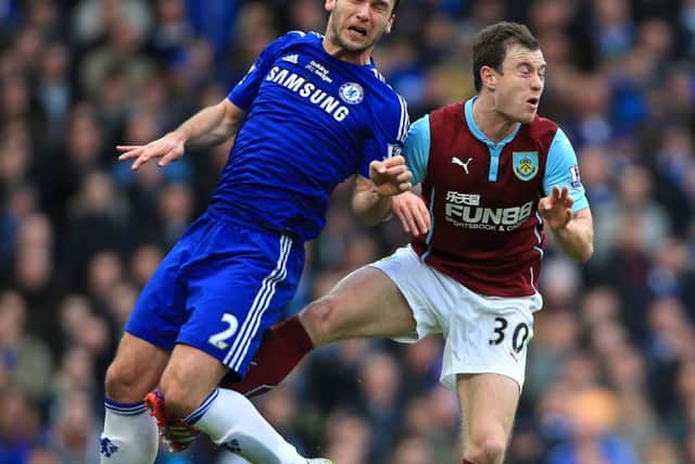 Chelsea's Branislav Ivanovic (left) and Burnley's Ashley Barnes in action during the Barclays Premier League match at Stamford Bridge, London. PRESS ASSOCIATION Photo. Picture date: Saturday February 21, 2015. See PA story SOCCER Chelsea. Photo credit should read: Nick Potts/PA Wire. RESTRICTIONS: Editorial use only. Maximum 45 images during a match. No video emulation or promotion as 'live'. No use in games, competitions, merchandise, betting or single club/player services. No use with unofficial audio, video, data, fixtures or club/league logos.