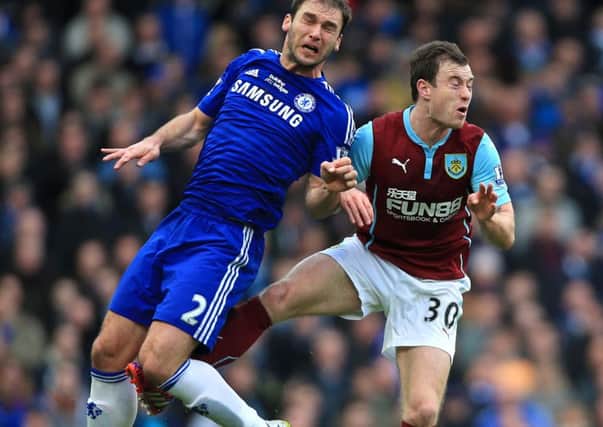Chelsea's Branislav Ivanovic (left) and Burnley's Ashley Barnes in action during the Barclays Premier League match at Stamford Bridge, London. PRESS ASSOCIATION Photo. Picture date: Saturday February 21, 2015. See PA story SOCCER Chelsea. Photo credit should read: Nick Potts/PA Wire. RESTRICTIONS: Editorial use only. Maximum 45 images during a match. No video emulation or promotion as 'live'. No use in games, competitions, merchandise, betting or single club/player services. No use with unofficial audio, video, data, fixtures or club/league logos.