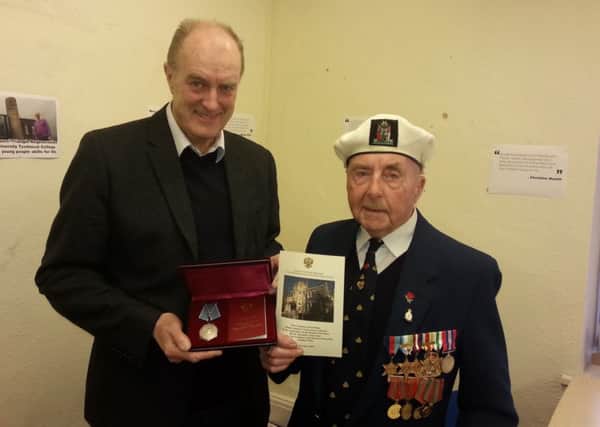 Burnley MP Gordon Birtwistle presents former Royal Navy sailor Jim Bates with his Ushakov medal from the Russian military