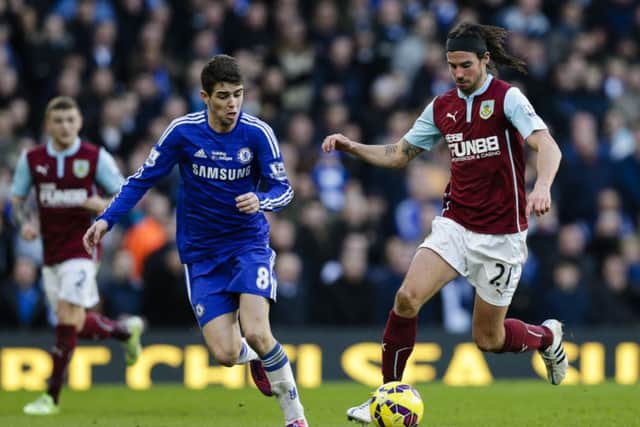 George Boyd looks to take the ball away from Chelsea star Oscar