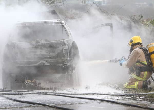 A fire-fighter at the scene of the car fire in Read.