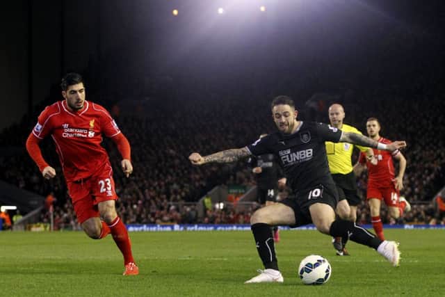Danny Ings tries to get a shot away under the watchful eye of Emre Can
