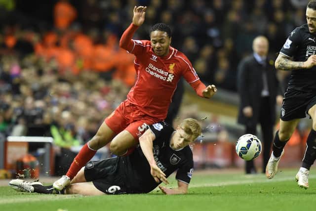 Liverpool's Raheem Sterling is tackled by Ben Mee