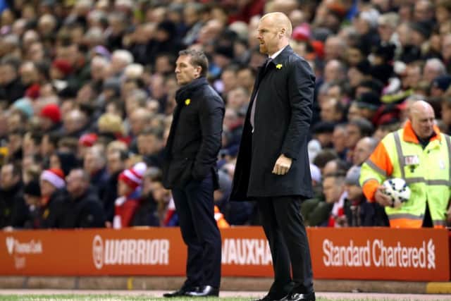 Sean Dyche and Liverpool manager Brendan Rodgers watch from the sidelines at Anfield