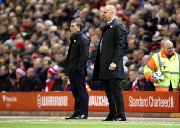 Sean Dyche and Liverpool manager Brendan Rodgers watch from the sidelines at Anfield
