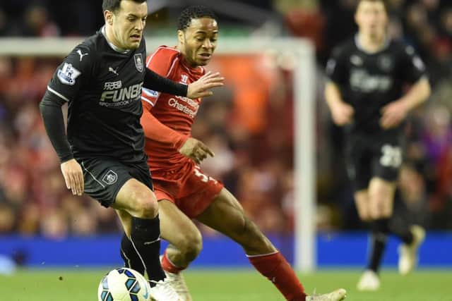 Looking sharp: Ross Wallace holds off Liverpool's Raheem Sterling