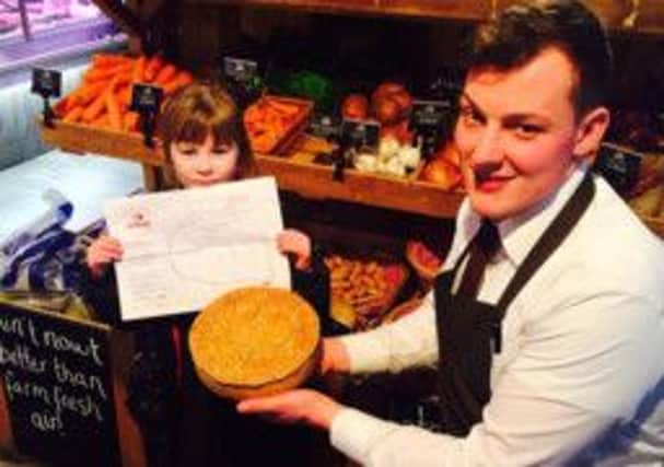 George Cropper presents Lexi Shaw with her winning pie