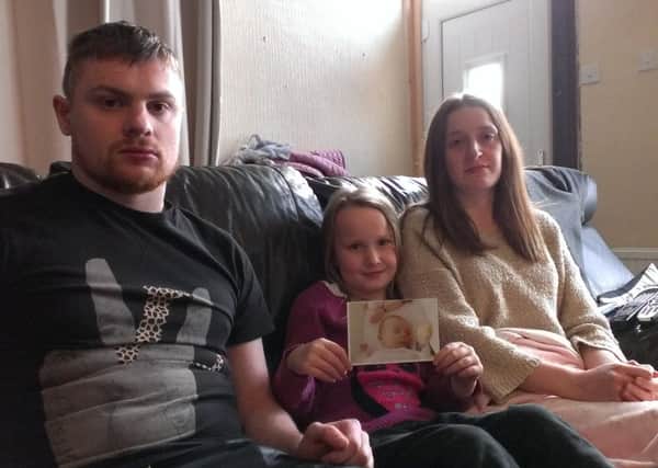 Kurt Hines (23), Katie Smithson (31) and Lydia-Sue Smithson (7) issue an emotional plea for the return of a laptop stolen in a burglary at their Chad Street home which contained photos of Lilly-Rose Hines.