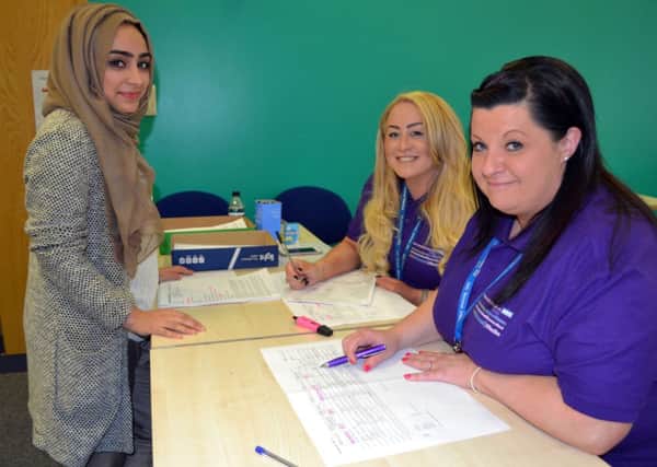 Administrators Lauren Staveley (centre) and Emma Askey (right) welcome an applicant for her interview (s)