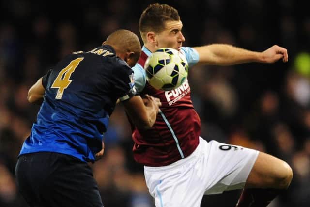 Clarets striker Sam Vokes in an aerial duel with Manchester City defender Vincent Kompany in the 1-0 win at the weekend