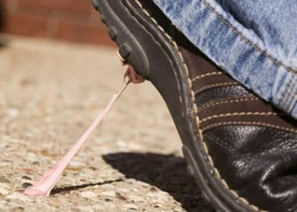 Chewing gum on a pavement stuck to a shoe