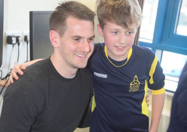 Tom Heaton poses for a picture with a pupil in a question and answer session at Blessed Trinity