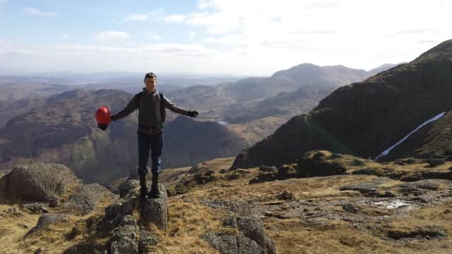 Reporter Dom Collis at the summit of Pavey Ark
