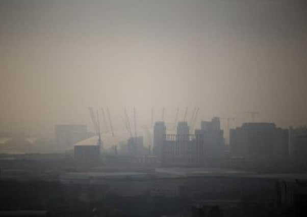 The Millennium Dome is shrouded in smog in London,
 (AP Photo/Matt Dunham)