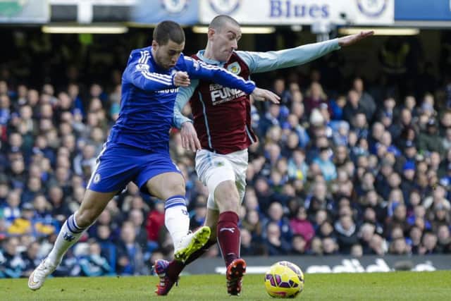 David Jones battles for possession with Chelsea's Eden Hazard