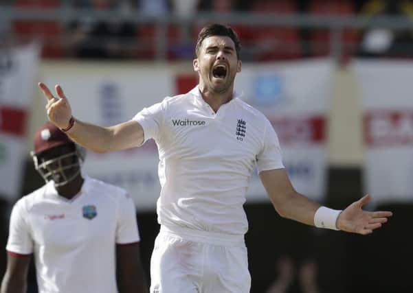 England's James Anderson, second from right, celebrates taking the wicket of West Indies' Denesh Ramdin