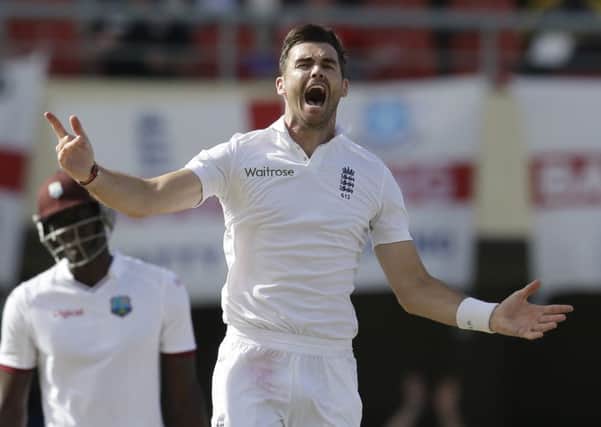 England's James Anderson, second from right, celebrates taking the wicket of West Indies' Denesh Ramdin, during the last day of their first cricket Test match at the Sir Vivian Richards Cricket Ground in Antigua, Antigua and Barbuda, Friday, April 17, 2015.  Anderson became the leading Test wicket-taker in England's cricket history. (AP Photo/Ricardo Mazalan)