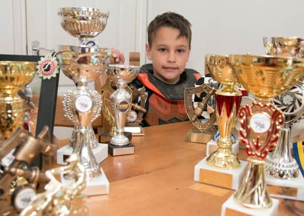 Motorcross star Marshall Kenny-Halstead (8) with a small selection of the trophies he has won.