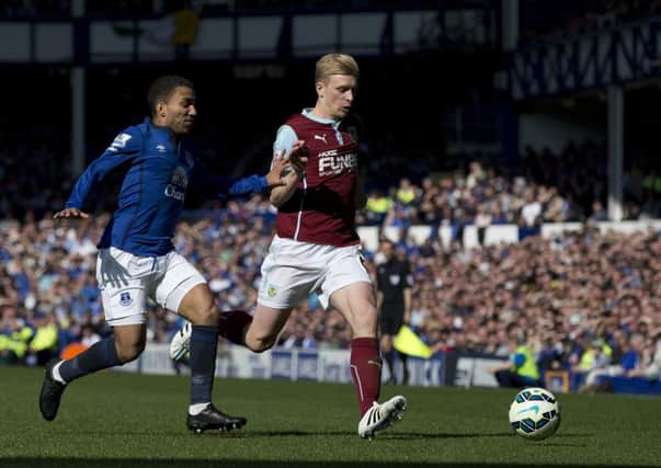 Burnley's Ben Mee shields the ball from Everton's Aaron Lennon