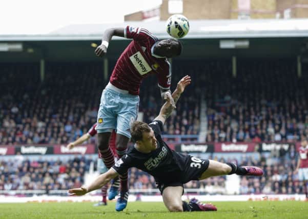 Ashley Barnes battles with West Ham United's Cheikhou Kouyate