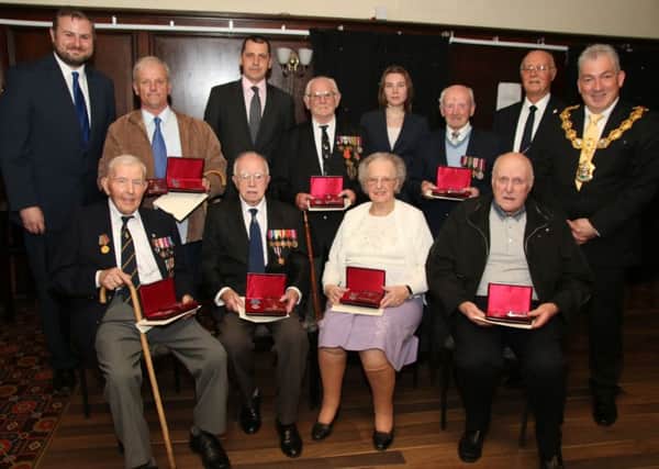 Pendle and Burnley World War Two veterans receive their Ushakov Medals to honour their efforts in the Artic Convoys from Lisa Vokorina and Sergey Belyakov.
