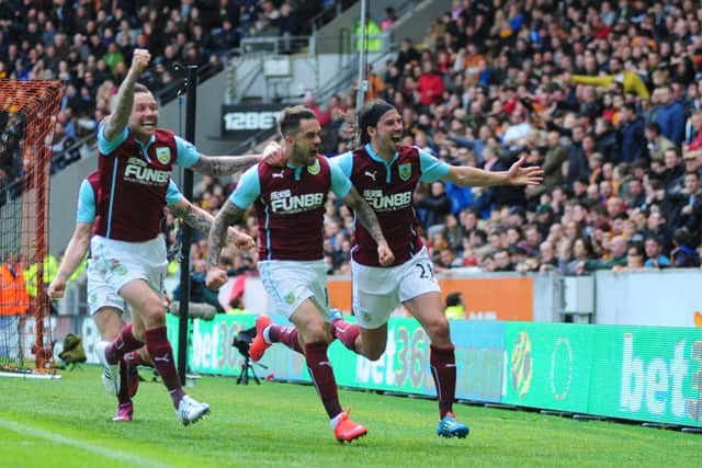 Danny Ings celebrates his goal with Matt Taylor and George Boyd