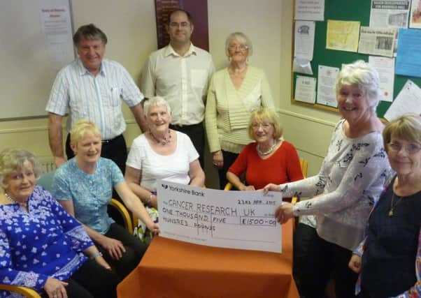 Brierfield Bridge Club members with the cheque they raised for Cancer Research UK