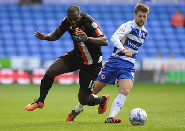 Oli Norwood in action for Reading against Blackpools Ishmael Miler