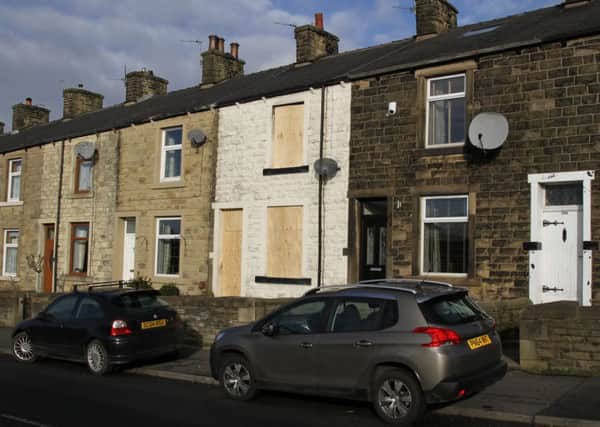 Read house fire in Whalley Road, Read.
Firefighters rescued a woman with severe burns to her face and arms from an upstairs window.
Pictured is the boarded up terraced house.