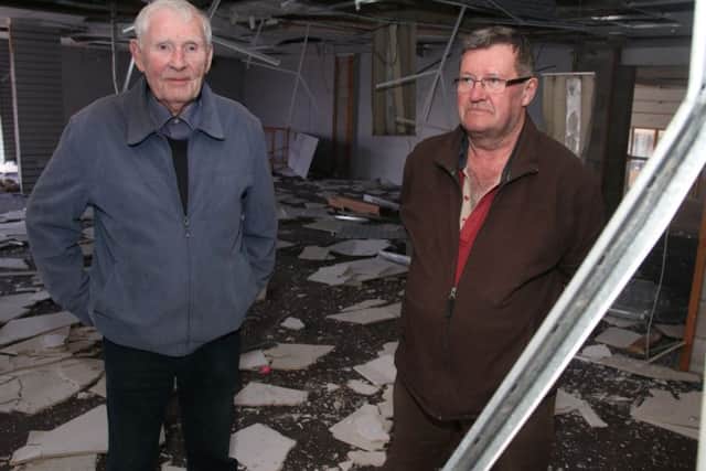 Tom Halpin and Stuart Cowgill in the damaged former Shafi store in the Victory Centre in Nelson.