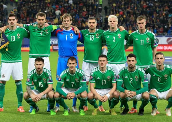Oliver Norwood, front row extreme left, lines up for Northern Ireland against Romania  last year in a European Championship qualifier in Bucharest