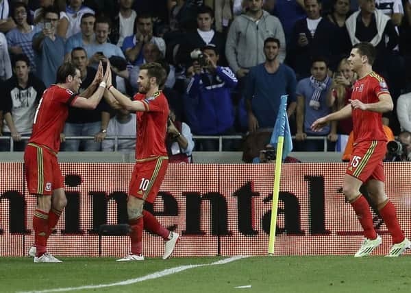 Sam Vokes runs to congratulate Gareth Bale after the Real Madrid forward scored against Israel earlier in the campaign