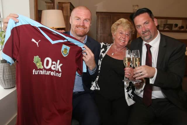 Burnley manager Sean Dyche with Oak furnitureland MD Jason Bannister and his mum Rita with the new 2015/16 season team shirt.