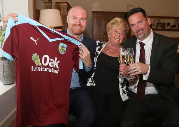 Burnley manager Sean Dyche with Oak furnitureland MD Jason Bannister and his mum Rita with the new 2015/16 season team shirt.