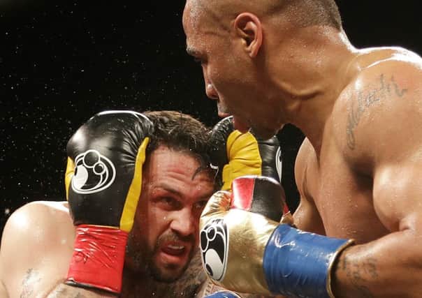 Andre Ward, right, punches Paul Smith during a cruiserweight boxing match in Oakland, Calif., Saturday, June 20, 2015. Ward won when Smith's corner threw in the towel in the ninth round. (AP Photo/Jeff Chiu)