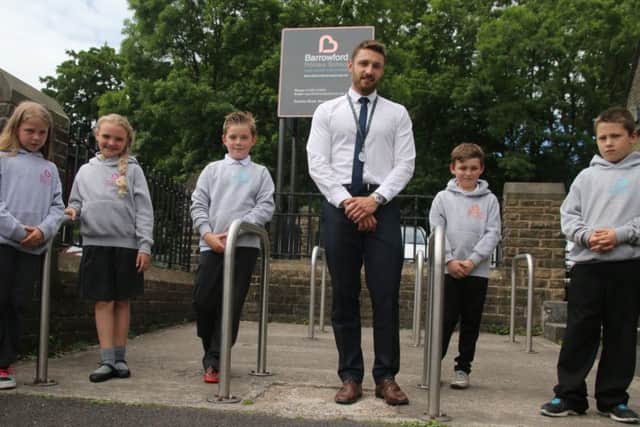 Barrowford Primary School year 5 teacher Mr Kark Cross and pupils where the school has a policy where no children are deemed naughty.