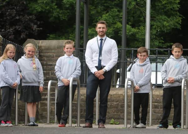 Barrowford Primary School year 5 teacher Mr Kark Cross and pupils where the school has a policy where no children are deemed naughty.