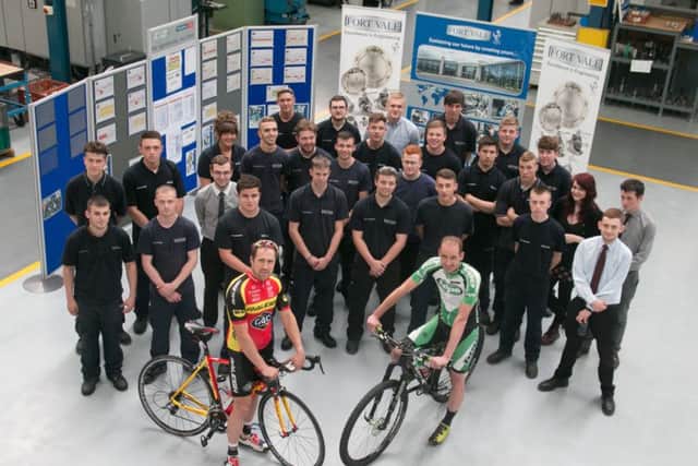 Cyclists Ian Wilkinson and Paul Oldham with apprentices at Fort Vale who are sponsoring this year's Colne Grand Prix.