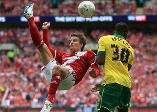 Middlesbrough's Jelle Vossen attempts an overhead kick as he is marked by Norwich City's Sebastien Bassong during the Sky Bet Championship Play Off Final at Wembley Stadium, London. PRESS ASSOCIATION Photo. Picture date: Monday May 25, 2015. See PA story SOCCER Championship. Photo credit should read: Nick Potts/PA Wire. RESTRICTIONS: Editorial use only. Maximum 45 images during a match. No video emulation or promotion as 'live'. No use in games, competitions, merchandise, betting or single club/player services. No use with unofficial audio, video, data, fixtures or club/league logos.