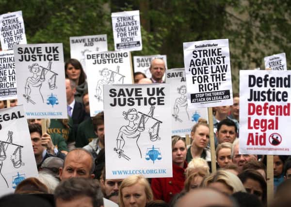 Protesters outside the Houses of Paliament in London, campaigning  against proposed changes to legal aid. Photo: Philip Toscano/PA Wire