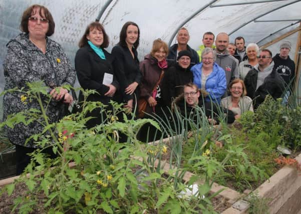 Employees, volunteers and guests during a tour during the open day at Pennine Lancashire Community Farm in March Street.