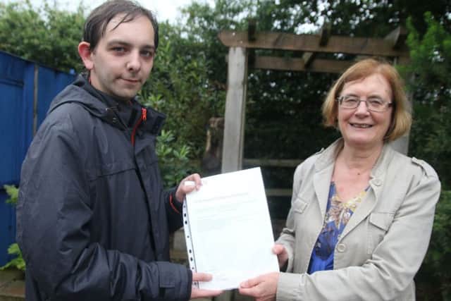 Andrew Williams is presented with his Step Program certificate by Lemora Priestley, chair of trustees of the Pennine Lancashire Community Farm in March Street.