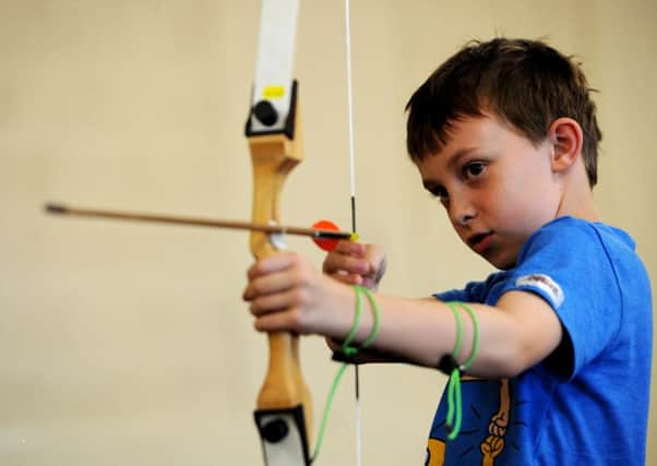 Evan Woodhouse (10) tries his hand with a  bow and arrow