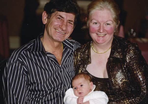 Ginio Ferrari with his wife Susan and their first grandchild