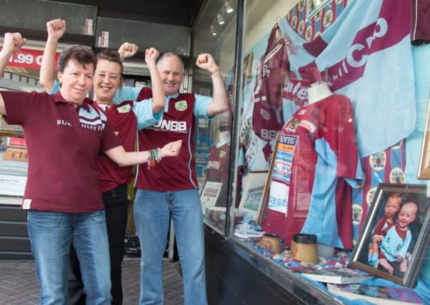 Sheila Jackson, June Heys (shop manager) and George Jackson with the Burnley FC memorabilia on display in the Age UK store in Burnley.
