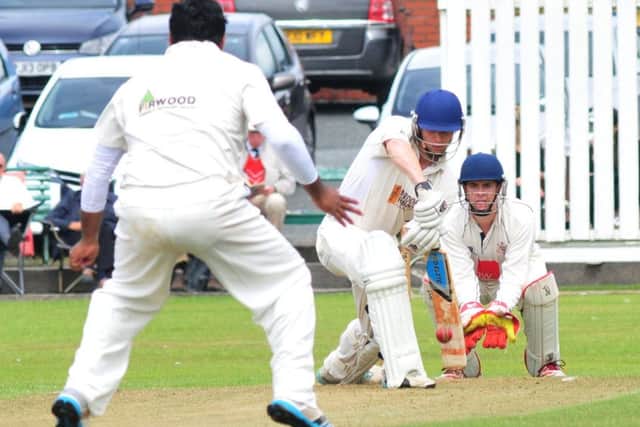 Nelson's wicket keeper Russell Bradley and Professional, Qaiser Abbas close in on Burnley's Chris Holt