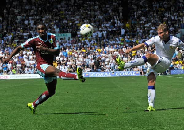Charlie Taylor crosses the ball past Tendayi Darikwa.
Leeds United v Burnley.  SkyBet Championship.  8 August 2015.  Picture Bruce Rollinson