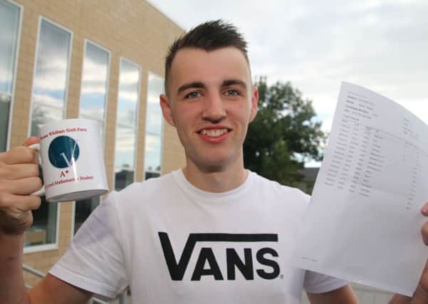 Thomas Whitham Sixth Form student Adam Gilbert with his special A* A-Level mathematics mug.