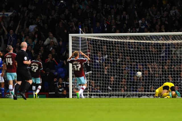 Tom Heaton is left on his knees after Ipswich Town's Freddie Sears opens the scoring.