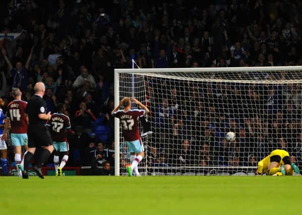 Tom Heaton is left on his knees after Ipswich Town's Freddie Sears opens the scoring.